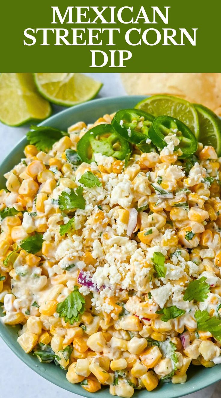 mexican street corn dip in a bowl with limes and cilantro on the side