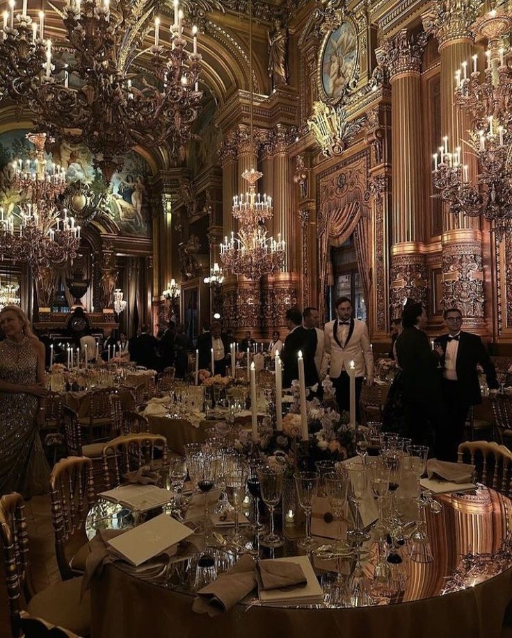 a fancy dining room with chandeliers and tables