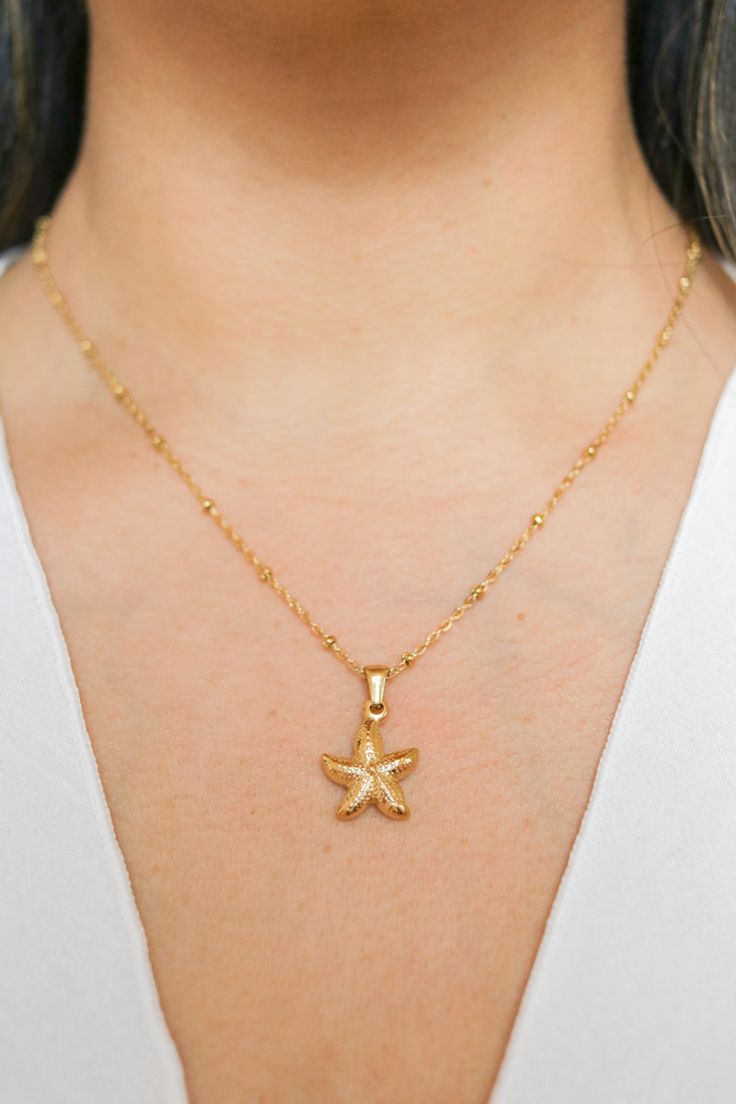 Introducing our Patricia Starfish Necklace, a charming piece inspired by coastal beauty. This necklace showcases a delicate starfish pendant, adding a subtle touch of seaside charm to your look. Versatile and understated, it's a lovely accessory for everyday wear, bringing a hint of coastal style to any outfit. All of our jewelry comes with a free jewelry pouch and cloth to keep your pretties safe and clean. Details Color: 18K Gold PlatedMaterial: Stainless SteelSize: 16in + 5cm extender Care Gu Dainty Starfish Necklace For Beach, Yellow Gold Starfish Charm Necklace For Beach, Yellow Gold Necklace With Starfish Charm For Beach, Yellow Gold Starfish Jewelry In Ocean-inspired Style, Ocean-inspired Necklaces With Star Charm, Ocean-inspired Jewelry With Star Charm, Yellow Gold Starfish Ocean-inspired Jewelry, Ocean-inspired Starfish Yellow Gold Jewelry, Elegant Starfish Charm Necklace For Beach