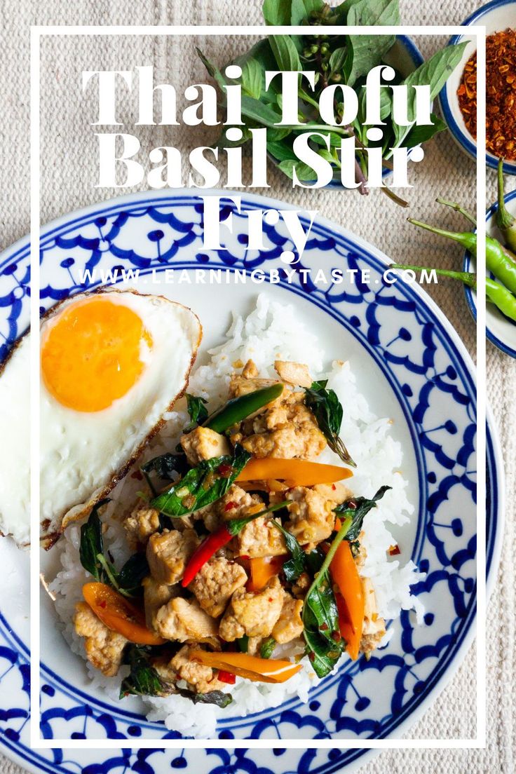 a blue and white plate topped with rice, meat and veggies next to an egg