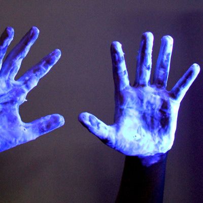 two hands with blue light painted on them