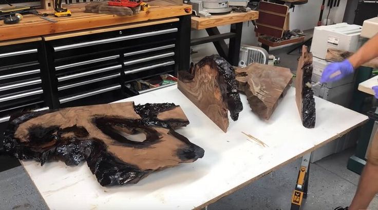 two people are working on wood in a shop