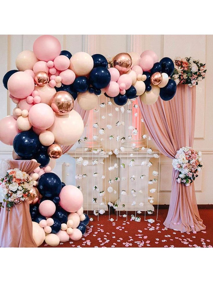 the balloon arch is decorated with black, pink and white balloons for an elegant wedding