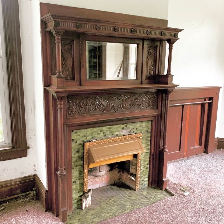 an old fireplace with a mirror above it