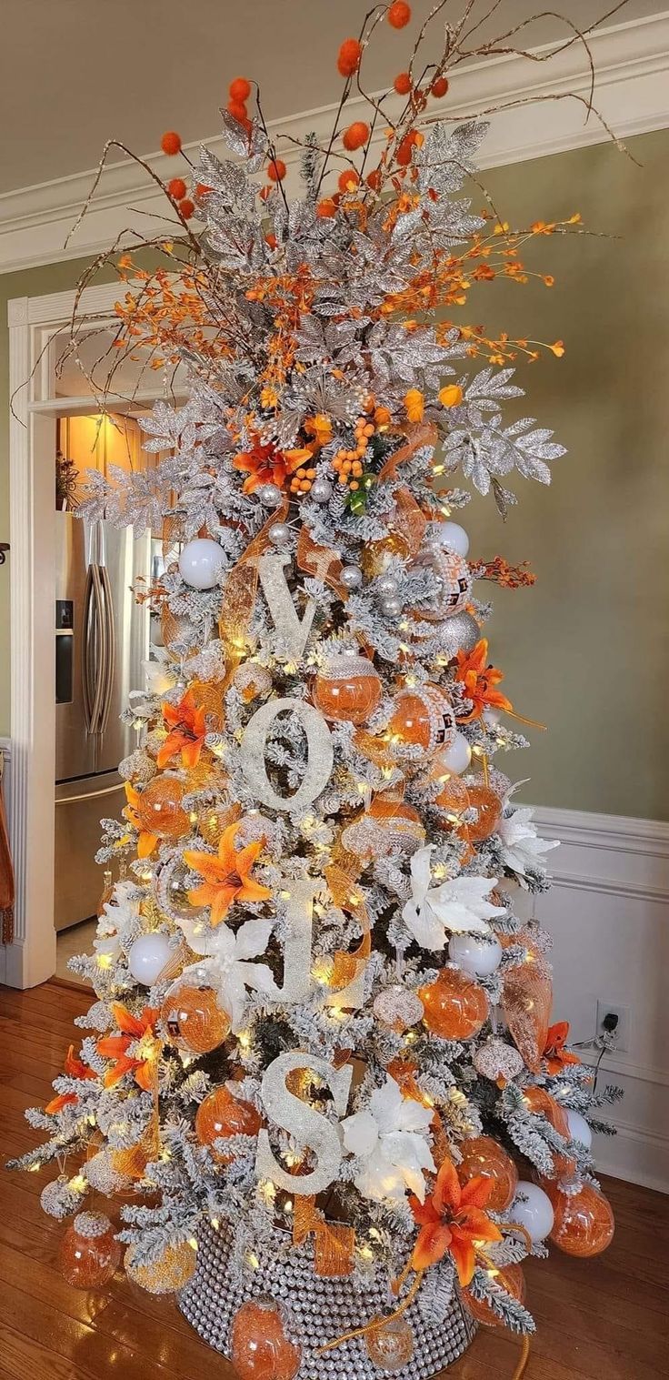 a decorated christmas tree with orange and white decorations