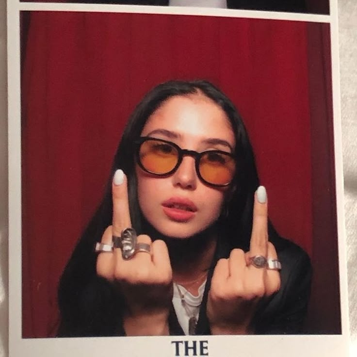 a woman wearing glasses holding up two fingers in front of her face with the caption, the truth is out