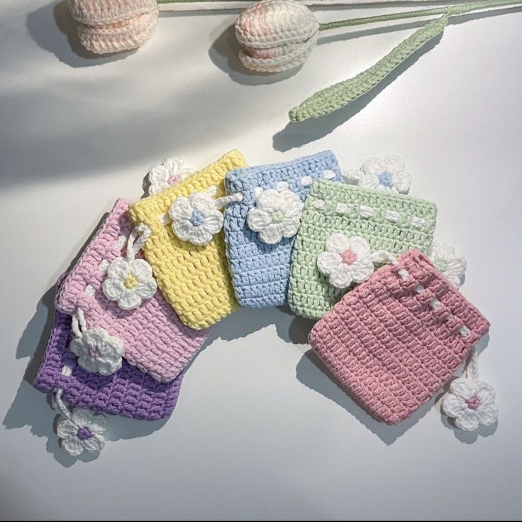 small crocheted purses are lined up on a table