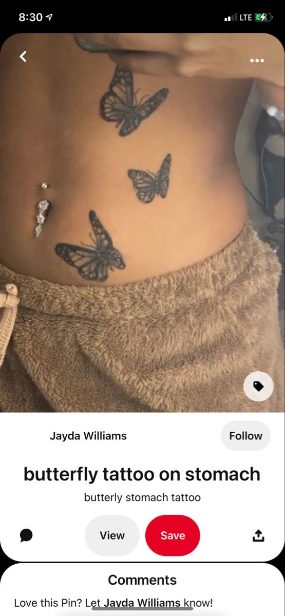 the back of a woman's stomach with butterfly tattoos on her belly and an arrow tattoo