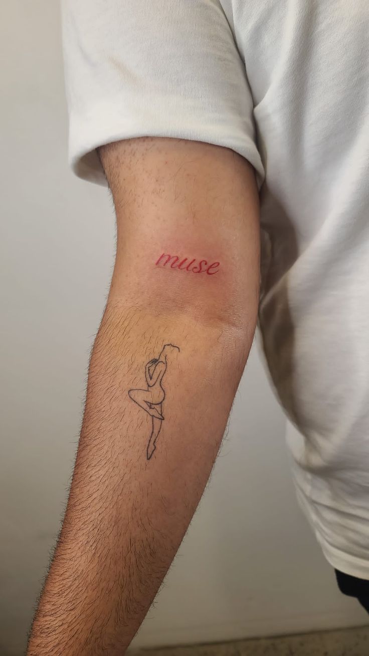 a man with a small tattoo on his arm that says, mamae in red ink