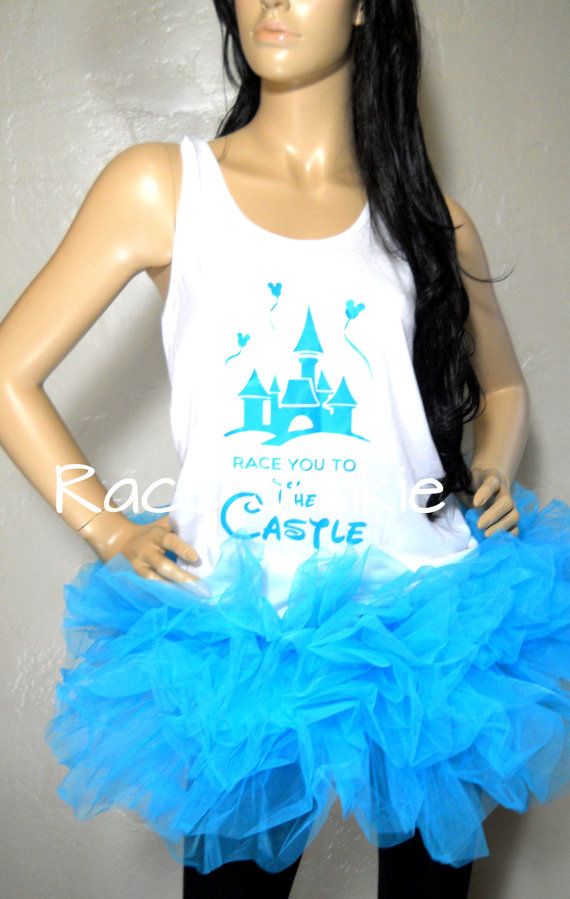 a female mannequin wearing a white tank top and blue tulle skirt with a castle on it