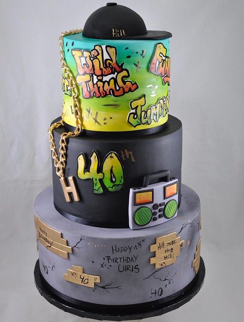 a three tiered cake decorated with various items on it's top and bottom