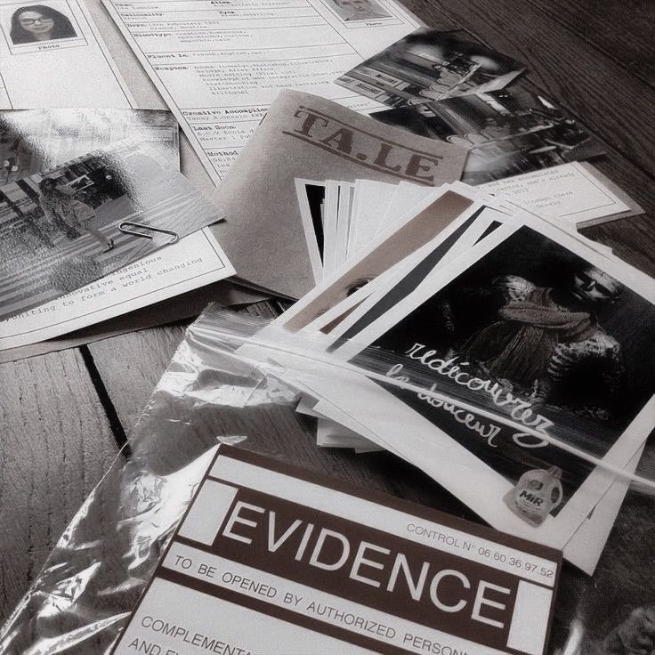 several newspapers are spread out on a wooden table, including one with the word evidence