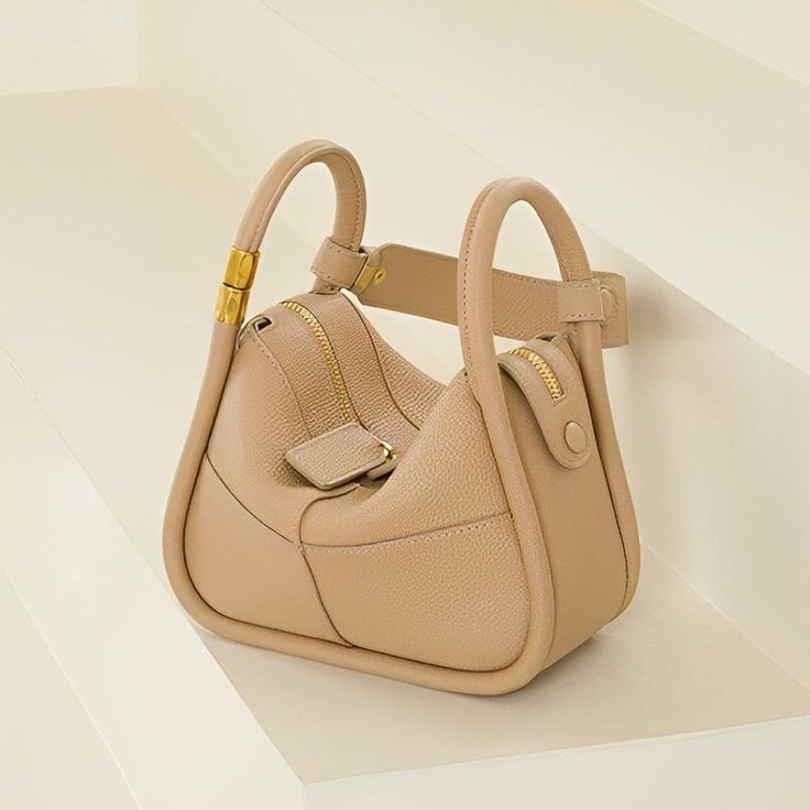 Looking for a versatile shoulder bag that oozes style and quality? Look no further than the Kelly Shoulder Bag! Lightweight and versatile, this bag is perfect for any occasion while easily fitting all your essentials. Whether dressed up or down, you'll confidently go anywhere with this must-have statement piece on your shoulder. Now available in beige and khaki. Beautiful Handbags, Two Daughters, Bracelet Set, I Dress, Heart Pendant, Leather Shoulder Bag, Jewelry Sets, Clutch Bag, Going Out