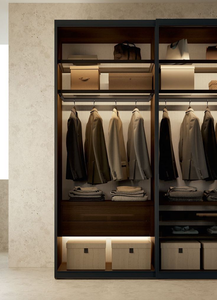 an open closet with clothes hanging on the shelves and drawers in front of each other