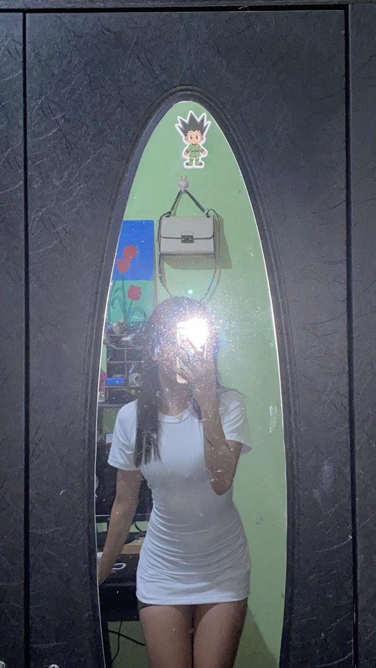 a woman taking a selfie in a mirror