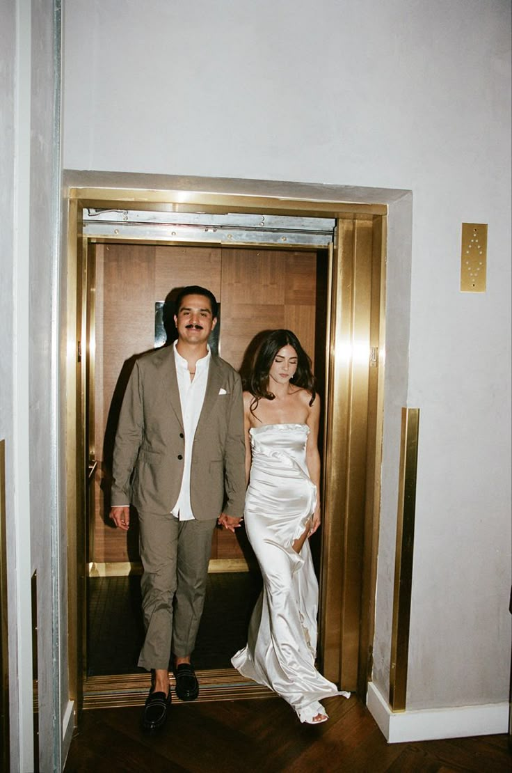 a man and woman standing in an elevator