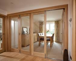 an open living room and dining area with sliding glass doors that lead into the kitchen