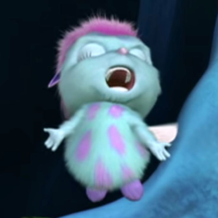 a stuffed animal with pink and green hair