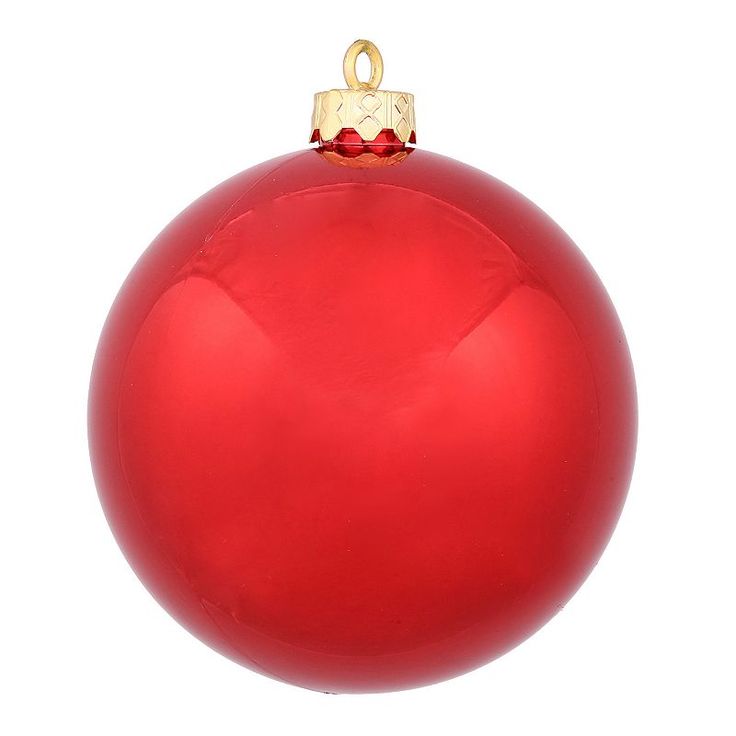 a red christmas ornament hanging from a gold - plated metal hook on a white background