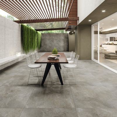 an outdoor dining area with concrete flooring and wooden slatted ceiling above the table