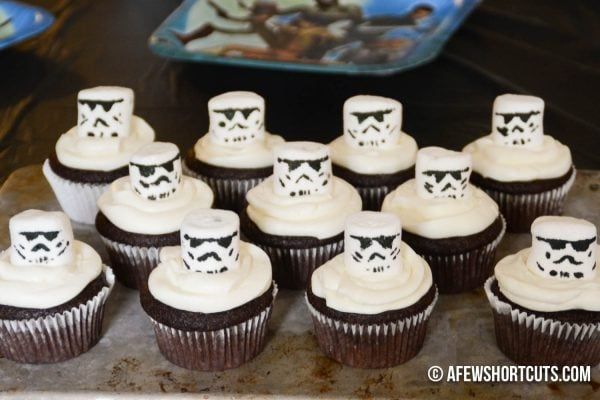 star wars cupcakes with white frosting and black decorations