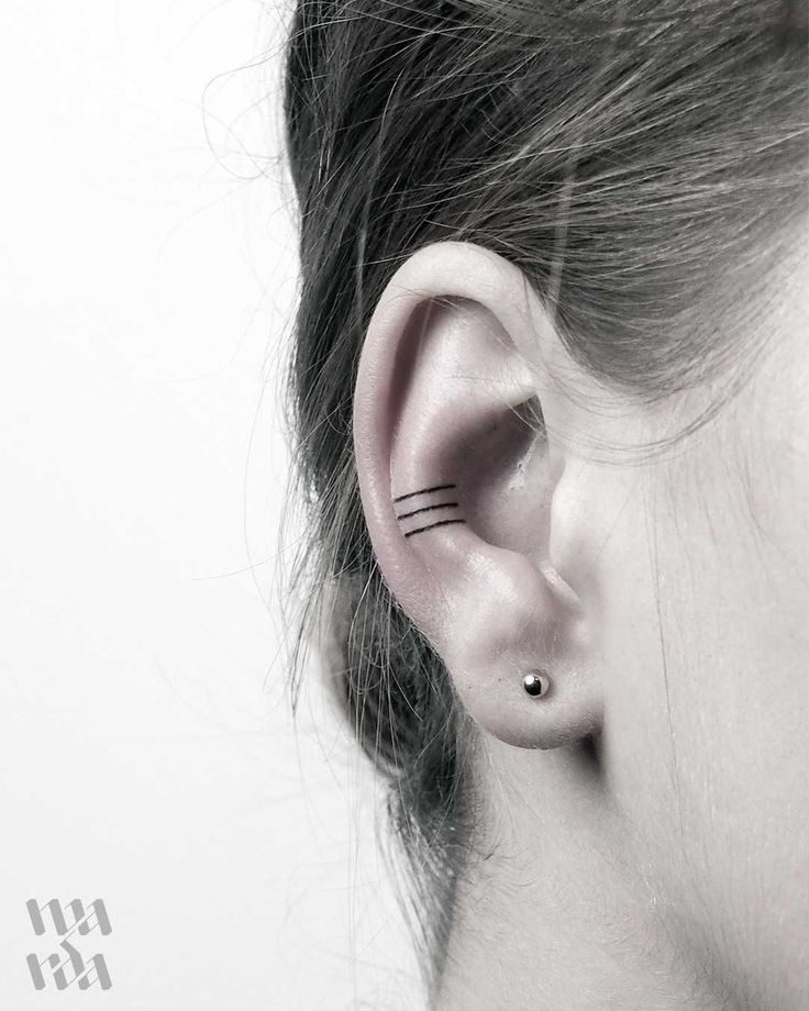 a woman's ear with black lines on it