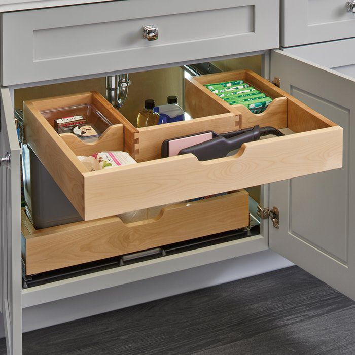 an open drawer in a kitchen filled with items