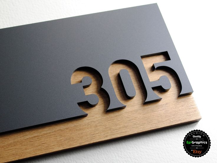 a wooden plaque with the number 350 on it