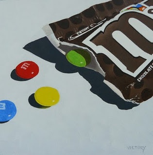 a bag of m & m's candy sitting on top of a white table