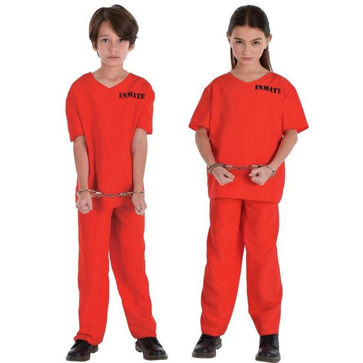 two children in orange prison uniforms with chains on their ankles and hands behind their backs