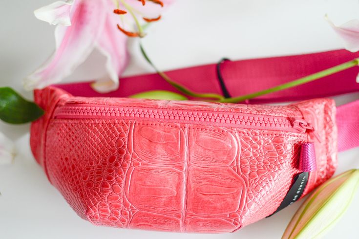 "ABOUT:  Pink embossed small fanny pack with black zipper and a small pouch pocket inside for storage. Adjustable pink strap with black buckle. Great for everyday style and vacations.  -------------------------------------------------------------------------------------------------------- DESCRIPTION:  - front zipper closure - pocket on back of pack - lined interior - inside pocket  - handmade Dimensions are approximately as follows: - 10.5\" Long x 4\" Tall x 2\" Width - straps are about 42\" long for crossbody wear (can be adjusted smaller) Color - pink bag - pink zipper - black buckle - pink straps *Actual colour may vary from picture due to computer settings. -------------------------------------------------------------------------------------------------------- MAIN FABRIC 100% PVC  L Black Fanny Pack, Banana Bag, Fur Top, Small Pouch, Sling Bags, Pretty Packaging, Small Pouches, Black Leather Bags, Black Chain