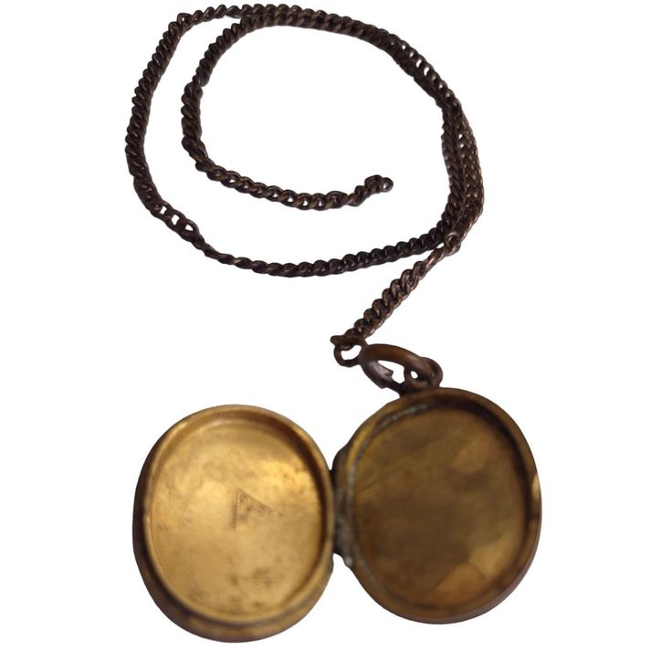 This vintage brass locket features intricate engravings and a sturdy chain. It opens to reveal two compartments for storing small keepsakes. * Brass material * Oval shape * Intricate engravings * Two compartments * Sturdy chain Surface wear and tarnish visible. Chain length = 20 inches, locket dimensions = 1.5 x 1 inches.Condition: Pre-Owned Poor Heavy usage seen on items exterior Victorian Style Brass Locket Jewelry, Vintage Brass Locket Necklace With Antique Finish, Victorian Round Brass Locket Necklace, Victorian Brass Locket Necklace For Vintage Collection, Victorian Oval Brass Locket Necklace, Train Book, Antique Locket, Brass Material, Locket Necklace