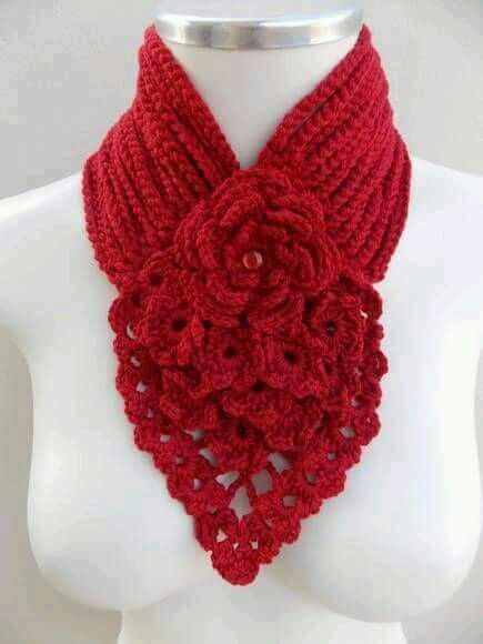 a red crocheted scarf on top of a white mannequin