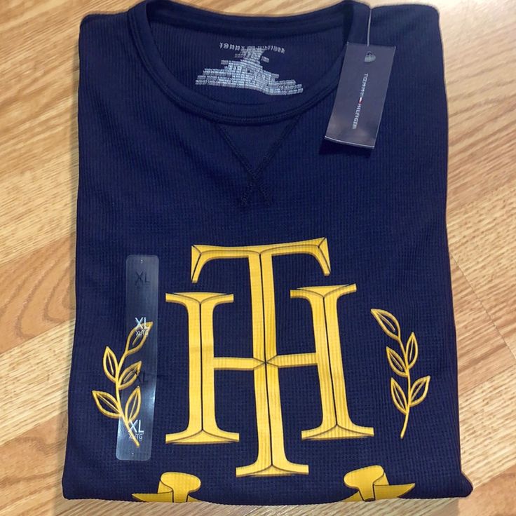 New With Tags. Navy Blue Thermal With Gold Logo. 29��” Shoulder Down, 21” Across Tommy Hilfiger Blue Relaxed Fit Top, Tommy Hilfiger Letter Print Tops For Fall, Blue Tommy Hilfiger T-shirt With Letter Print, Tommy Hilfiger Blue T-shirt With Letter Print, Tommy Hilfiger Long Sleeve Casual T-shirt, Casual Long Sleeve T-shirt By Tommy Hilfiger, Casual Long Sleeve Tommy Hilfiger T-shirt, Casual Navy Tommy Hilfiger Top, Rugby Tee