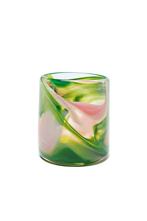 a green and pink vase sitting on top of a white table