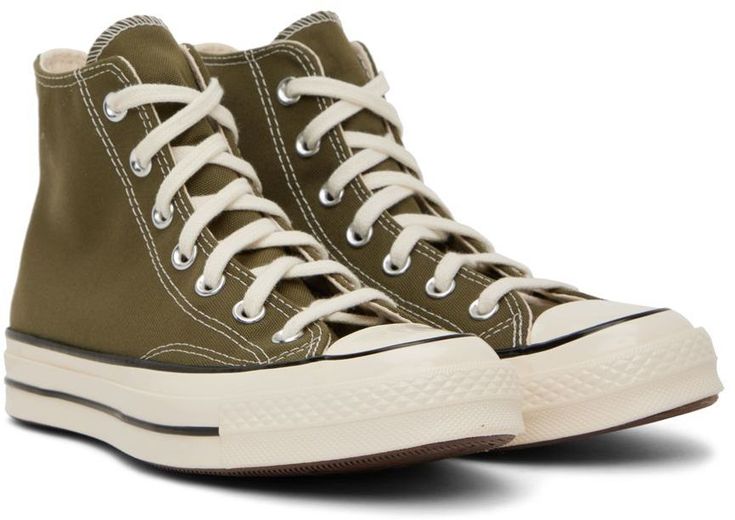 High-top canvas sneakers in khaki. · Round rubber cap toe · Lace-up closure · Logo patch at inner side · Metal eyelet vents at inner side · Logo patch at heel · Rubber midsole in off-white · Treaded rubber outsole in brown Supplier color: Utility/Egret/Black 2023 Clothing, Hightop Sneakers, Chuck 70, Converse Sneakers, Mens Sportswear, Sneaker Collection, Canvas Sneakers, Chuck Taylor Sneakers, Converse High Top Sneaker