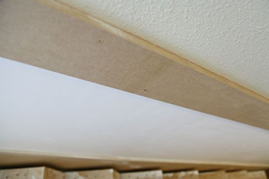 a close up view of the bottom part of a shelf with some wood planks on it