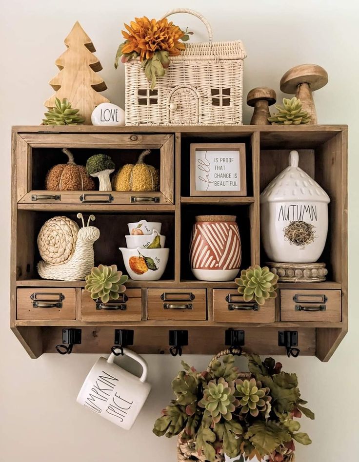 a shelf filled with lots of different types of items on top of each other next to a potted plant