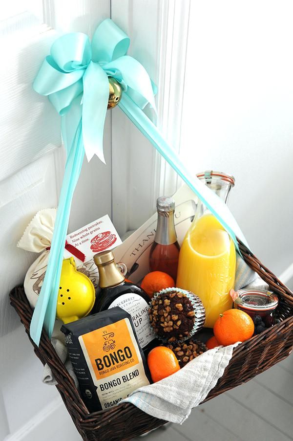 a wicker basket filled with assorted condiments and drinks sitting on a door sill