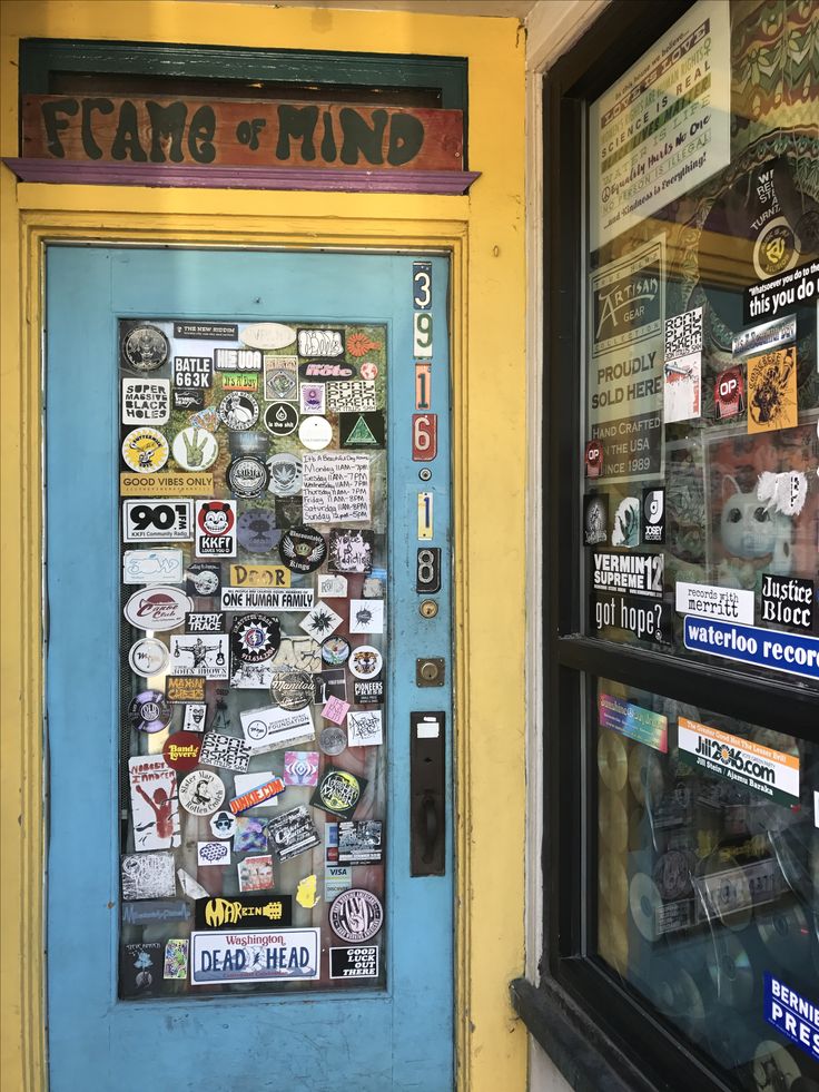 a store front with many stickers on it's glass door and the words fear & find