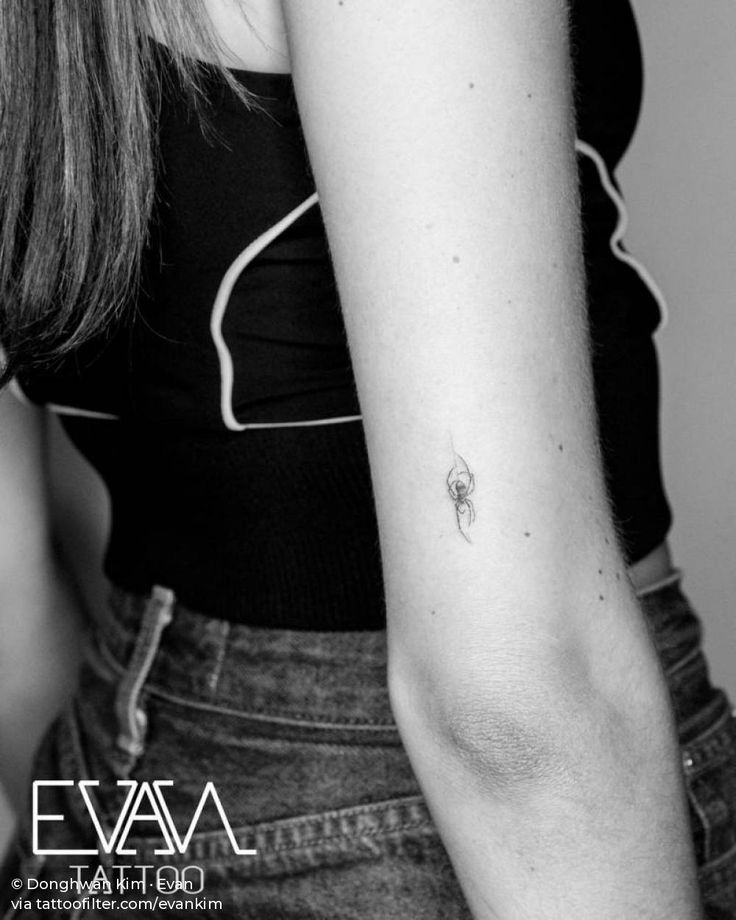 a woman with a small tattoo on her arm