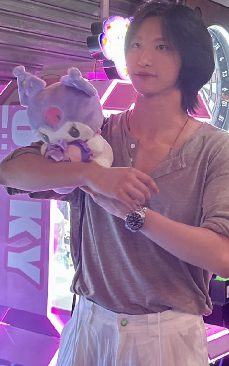 a woman holding a stuffed animal in her hand