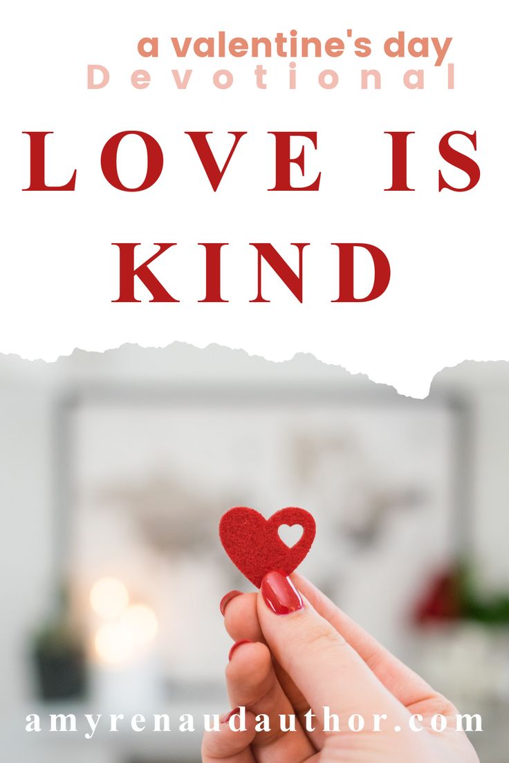 someone holding a red heart in their hand with the words love is kind above it