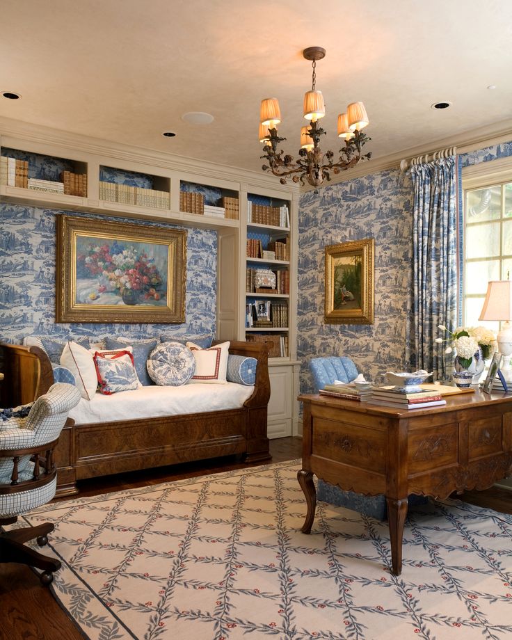 a living room filled with furniture and a chandelier hanging from the ceiling over a window