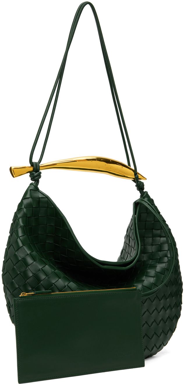 Intrecciato-woven buffed lambskin shoulder bag in green. · Sculptural metal carry handle · Fixed shoulder strap · Magnetic closure · Detachable zip pouch at interior · Unlined · Gold-tone hardware · H13 x W15 x D1 Supplier color: Emerald green Luxury Shoulder Bag With Braided Handles, Green Handheld Shoulder Bag With Gold-tone Hardware, Luxury Handheld Woven Leather Shoulder Bag, Luxury Green Hobo Bag With Detachable Handle, Chic Green Shoulder Bag With Round Handle, Luxury Green Crossbody Hobo Bag, Green Luxury Hobo Bag With Detachable Strap, Green Shoulder Bag With Detachable Strap And Round Handle, Formal Handheld Shoulder Bag With Braided Handles