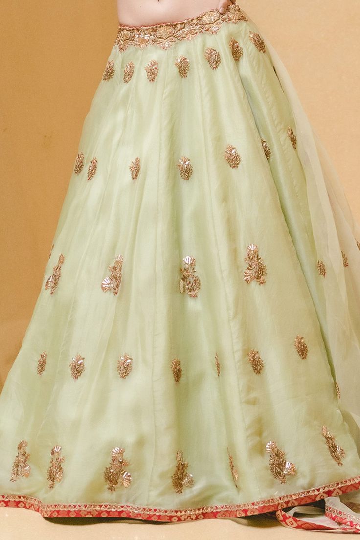 Pastel green lehenga with attached cancan, all-over floral zardozi embroidery and sequin embellishments. Comes with padded blouse and dupatta.
Component: 3
Embroidered
Neckline: Round
Sleeve Length: Three Quarter
Fabric: Lehenga and Dupatta: Organza; Blouse: Banarasi
Color: Green
Dori, mukaish, pearls, zardozi and resham embroidery
Embroidered blouse and dupatta
Cutout at the back - Aza Fashions Green Lehenga With Resham Embroidery For Reception, Semi-stitched Green Lehenga With Pallu, Green Floor-length Choli With Resham Embroidery, Green Lehenga With Resham Embroidery For Festivals, Green Lehenga With Resham Embroidery For Festive Occasions, Green Lehenga With Zari Work For Navratri, Festive Green Lehenga With Resham Embroidery, Semi-stitched Pista Green Choli For Eid, Green Anarkali Lehenga For Reception