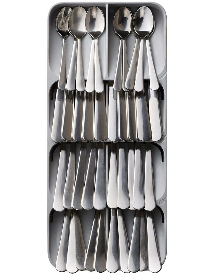 spoons, forks and knives are arranged in a divided tray on a white background