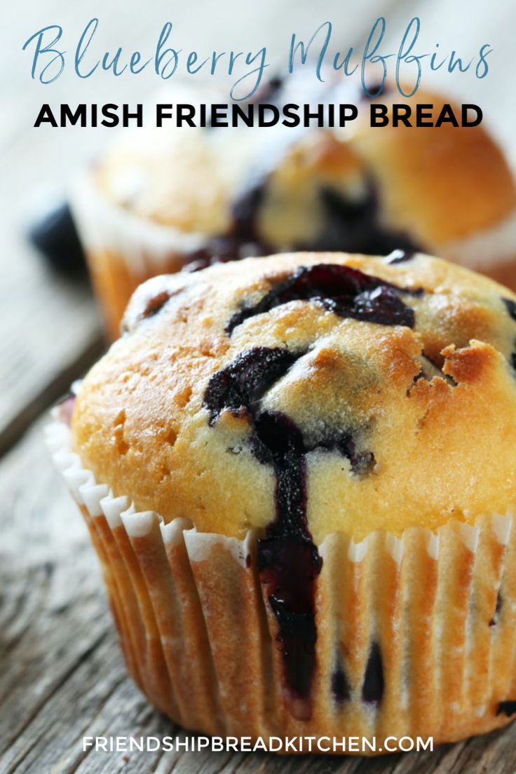 two blueberry muffins are sitting on a wooden table with the words, blueberry muffins amish friend bread