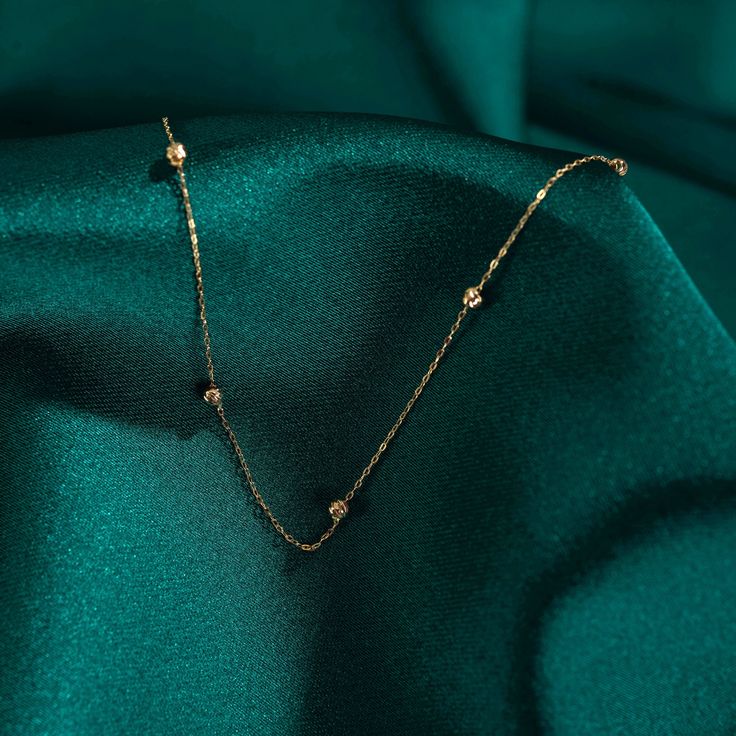 "14k Gold Beaded Satellite Necklace, Perfect for Everyday Wear, Minimalist Necklace, Beaded Chain, Layering Necklace, Gift for Her DIALOOK JEWELRY ITEM DETAILS Material: 14K Solid GOLD (Not Filled or Plated). Gold Necklace Chain Length: 16,7\" inch (42,5cm) Main Chain and 1\" inch (2,5cm) Adjustable Chain Part Total: 17,7\" inch (45cm) Chain Width: 1mm Finish: 14K Yellow Gold Featuring: 2,5mm Balls Stone: Zircon Each order will be beautifully packaged for gift giving in a jewelry box with an add Elegant Beaded Necklaces With Adjustable Chain, Elegant Chain Necklace With Adjustable Chain And Round Beads, Dainty Beaded Chain Necklace For Formal Occasions, Dainty Satellite Chain Necklace For Formal Occasions, Dainty Satellite Chain Necklace For Formal Events, Elegant Station Necklace With Adjustable Chain As Gift, Dainty Formal Satellite Chain Necklace, Minimalist Necklace With Round Beads And Clavicle Chain, Rose Gold Beaded Chain Necklace As Gift