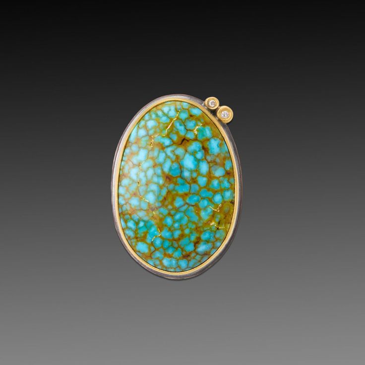 This stunning ring features vibrant blue-green turquoise, veined with the most intriguing golden inclusion patterns. Stone is wrapped in 22k gold and accented with a pair of sparkling diamonds set in 22k gold. Sterling silver back and 4mm hammered band. Stone measures approximately 1/2 inch x 3/4 inch. Matte finish. Unique Yellow Gold Oval Turquoise Ring, Gold Oval Turquoise Multi-stone Ring, Gold Turquoise Multi-stone Oval Ring, Gold Oval Multi-stone Turquoise Ring, Oval Turquoise Multi-stone Jewelry, Luxury Gold Multi-stone Turquoise Ring, Luxury Yellow Gold Turquoise Cabochon Ring, Turquoise Multi-stone 14k Gold Jewelry, Luxury Yellow Gold Turquoise Ring, Oval Cabochon